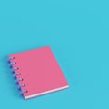 Pink notepad on bright blue background in pastel colors