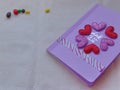 Notepad pink with hearts near candy on canvas Royalty Free Stock Photo