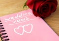 Pink notepad with wedding vows and rose. Royalty Free Stock Photo