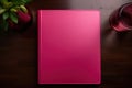 A pink notepad for writing lies on the desktop in the office