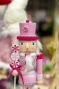 Pink nutcracker man, wooden Christmas toy on  store shelf. Royalty Free Stock Photo