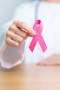 Pink October Breast Cancer Awareness month, woman doctor with pink Ribbon in hospital for support people life and illness. Royalty Free Stock Photo