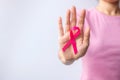 Pink October Breast Cancer Awareness month, woman hand hold pink Ribbon and wear shirt for support people life and illness. Royalty Free Stock Photo