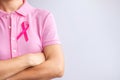 Pink October Breast Cancer Awareness month, woman hand hold pink Ribbon and wear shirt for support people life and illness. Royalty Free Stock Photo