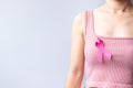 Pink October Breast Cancer Awareness month, woman hand hold pink Ribbon and wear shirt for support people life and illness. Royalty Free Stock Photo