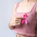 Pink October Breast Cancer Awareness month, woman hand hold pink Ribbon and wear shirt for support people life and illness. Royalty Free Stock Photo