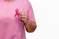 Pink October Breast Cancer Awareness month, woman hand hold pink Ribbon and wear shirt for support people life and illness. Royalty Free Stock Photo