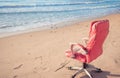 Pink office chair on beach