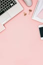 Pink office desk with electronic devices and copy space