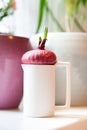 Pink onion in white cup