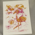 Pink and orange flamingo print on paper