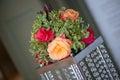 Pink and orange roses beautifully arranged in a round delicate bouquet