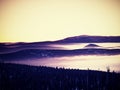 Pink orange sun rise above misty winter mountains Royalty Free Stock Photo