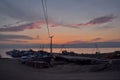 pink orange sunset with clouds in the sky in bay of the lake baikal with path on dock pier with old ships and boats, evening sea Royalty Free Stock Photo