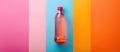 Pink and Orange Water Bottle on Multicolored Wall