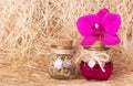 Pink orchid and two glass bottles on natural fiber sisal. Spa concept. Cosmetic bottles. Ecological natural cosmetics. Copy