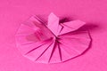 Pink origami butterfly and blossom over pink