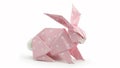 Pink origami folded easter bunny with polka dots, isolated on white background