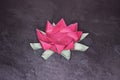 Pink Origami Lotus Flower - Paper Art on Textured Background Royalty Free Stock Photo