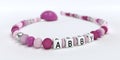 A pink pacifier chain for girls with name Abby