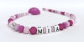 A pink pacifier chain for girls with name Mia Royalty Free Stock Photo