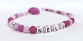 A pink pacifier chain for girls with name Nele Royalty Free Stock Photo