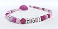 A pink pacifier chain for girls with name Zoe