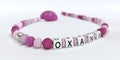 A pink pacifier chain for girls with name Oxana