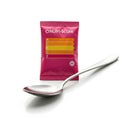 A pink packet labeled Nutri-Score with a color-coded scale showing letters A, C, E, and a silver spoon placed beside it.