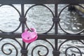 Pink padlock in the shape of heart closed by newlyweds on their wedding day. Symbol of eternal love and fidelity on forged metal Royalty Free Stock Photo