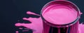 Pink paint can with spilled paint on dark background. Art and creativity concept Royalty Free Stock Photo