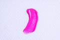 Pink paint swatch on white paper background. Bright pink swatch of lip gloss, cosmetic product stroke gouache, oil paint texture,