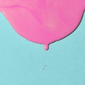 pink paint texture on blue canvas. Minimalistic background with copy space. Creative concept