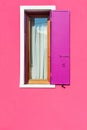 Pink painted facade of the house and window with pink shutters Royalty Free Stock Photo