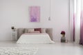 Pink painting in spacious bedroom