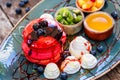 Pink pancakes with honey, chocolate, jam, whipped cream, berries and fruits on plate Royalty Free Stock Photo