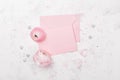 Pink paper blank and ranunculus flower on white table top view for wedding mockup or greeting card on mother day in flat lay style Royalty Free Stock Photo