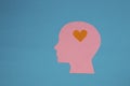 pink paper head instead of brain has a little orange heart, infatuation, flat design, human emotions,copy space