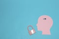 pink paper head with small key for locked pink padlock, copy space Royalty Free Stock Photo