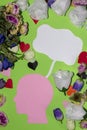 pink paper head with white bubble above as copy space, around lots of flowers and hearts
