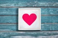 Pink paper heart in white cardboard box on vintage blue wooden background Royalty Free Stock Photo