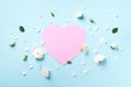 Pink paper heart, white roses and petals on blue pastel background. Spring or summer concept. Creative layout. Top view, flat lay Royalty Free Stock Photo