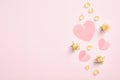 Pink paper hearts and yellow rose buds flowers and petals on pastel pink background. Valentines day flat lay style composition, Royalty Free Stock Photo