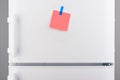 Pink paper note attached with blue sticker on white refrigerator Royalty Free Stock Photo