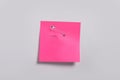 Pink paper note attached with safety pin to white background, top view Royalty Free Stock Photo