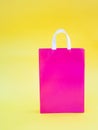 Pink paper  package  on a yellow background Royalty Free Stock Photo