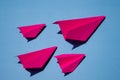 Pink Paper Plane or Paper Airplane Origami on Blue Background Top View with Place for Text, business competition concept Royalty Free Stock Photo