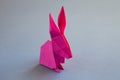 Pink paper rabbit origami isolated on a grey background Royalty Free Stock Photo