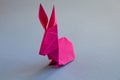 Pink paper rabbit origami isolated on a grey background Royalty Free Stock Photo