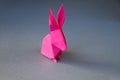 Pink paper rabbit origami isolated on a grey background Royalty Free Stock Photo